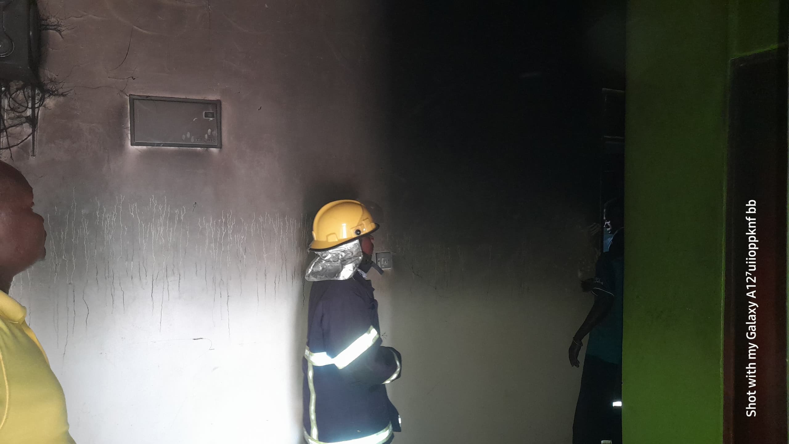 Firefighter inside the smoke-blackened dormitory room