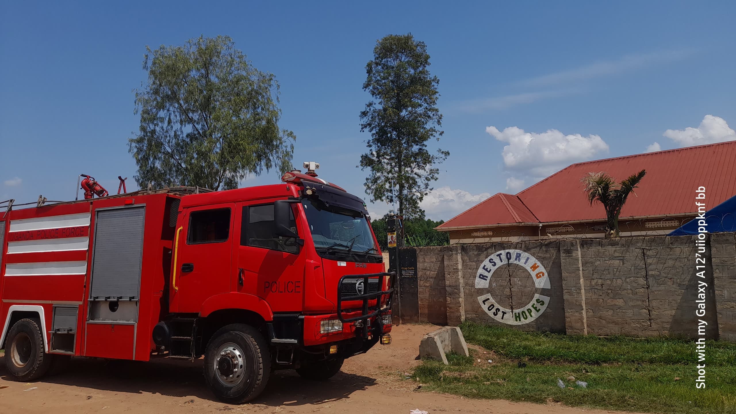 Fire truck at the Saved By Music Foundation gate with Restoring Lost Hopes sign