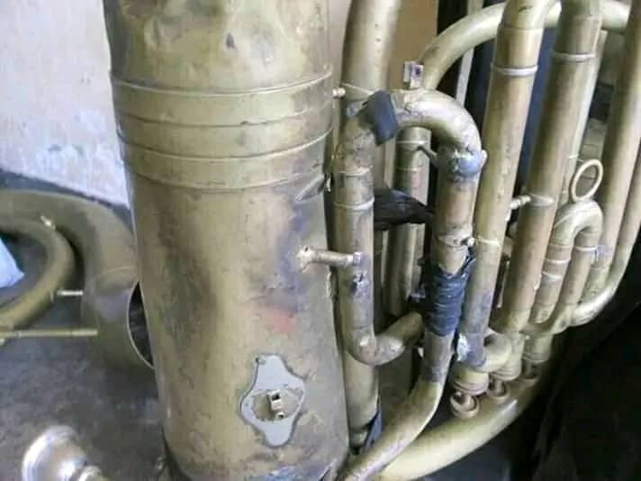A worn and damaged tuba — instruments are scarce and expensive in Uganda